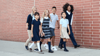 a group of kids and teens wearing school uniforms