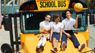 three kids with schoolbus