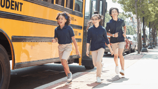 Kids in navy polo tops and khaki bottoms